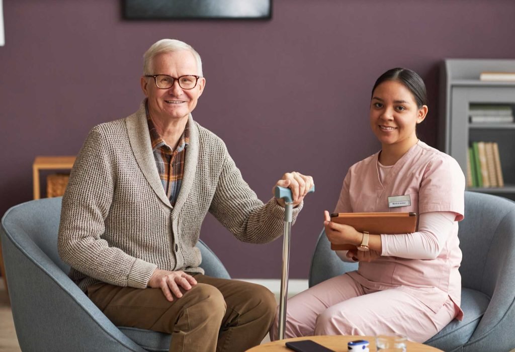senior-man-and-social-worker-sitting-at-home-care-life-touch